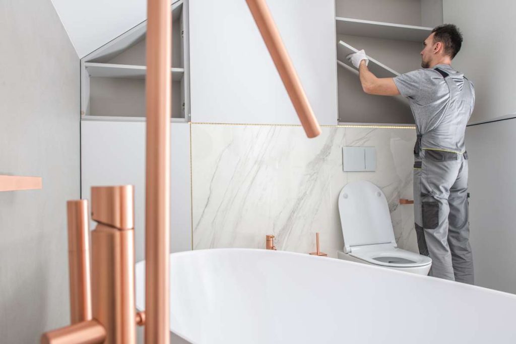 athroom renovations Perth homeowners can plan with confidence. Tiling, plumbing, fixtures, layout, and finishes handled by one team from start to finish. Bathroom Storage Building by Caucasian Home Improvement Worker. Elegant Modern Bathroom Interior.